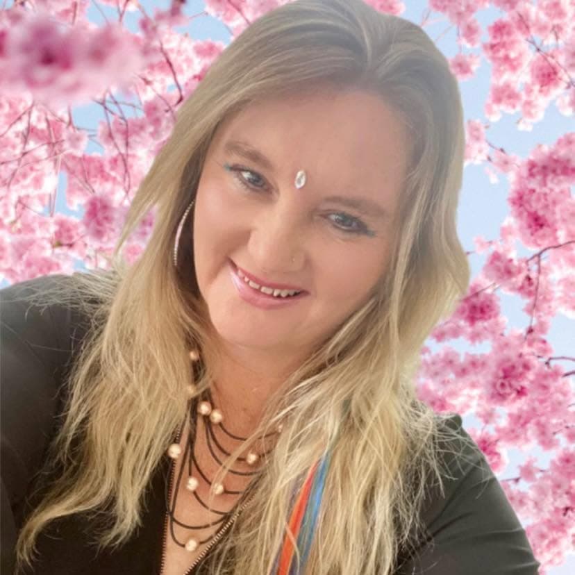 Nic smiling against pink cherry blossoms