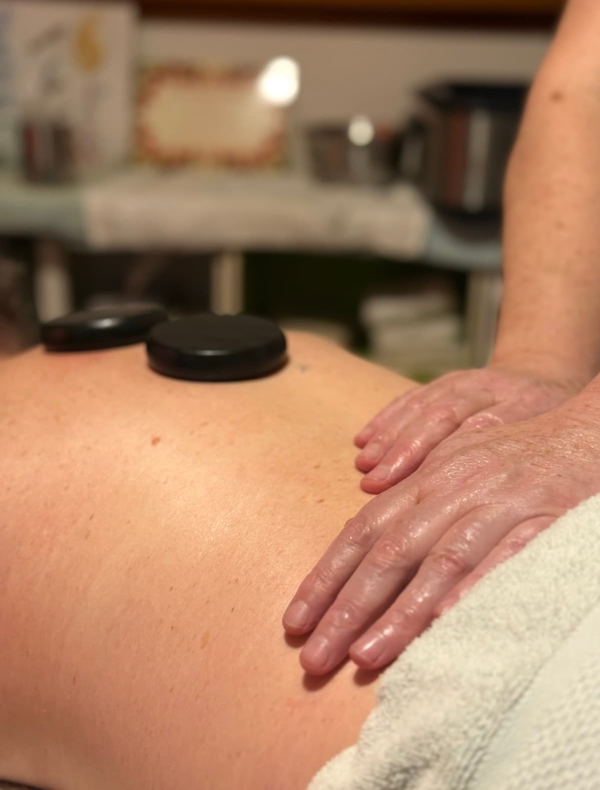 Nic providing a comforting hot stone massage