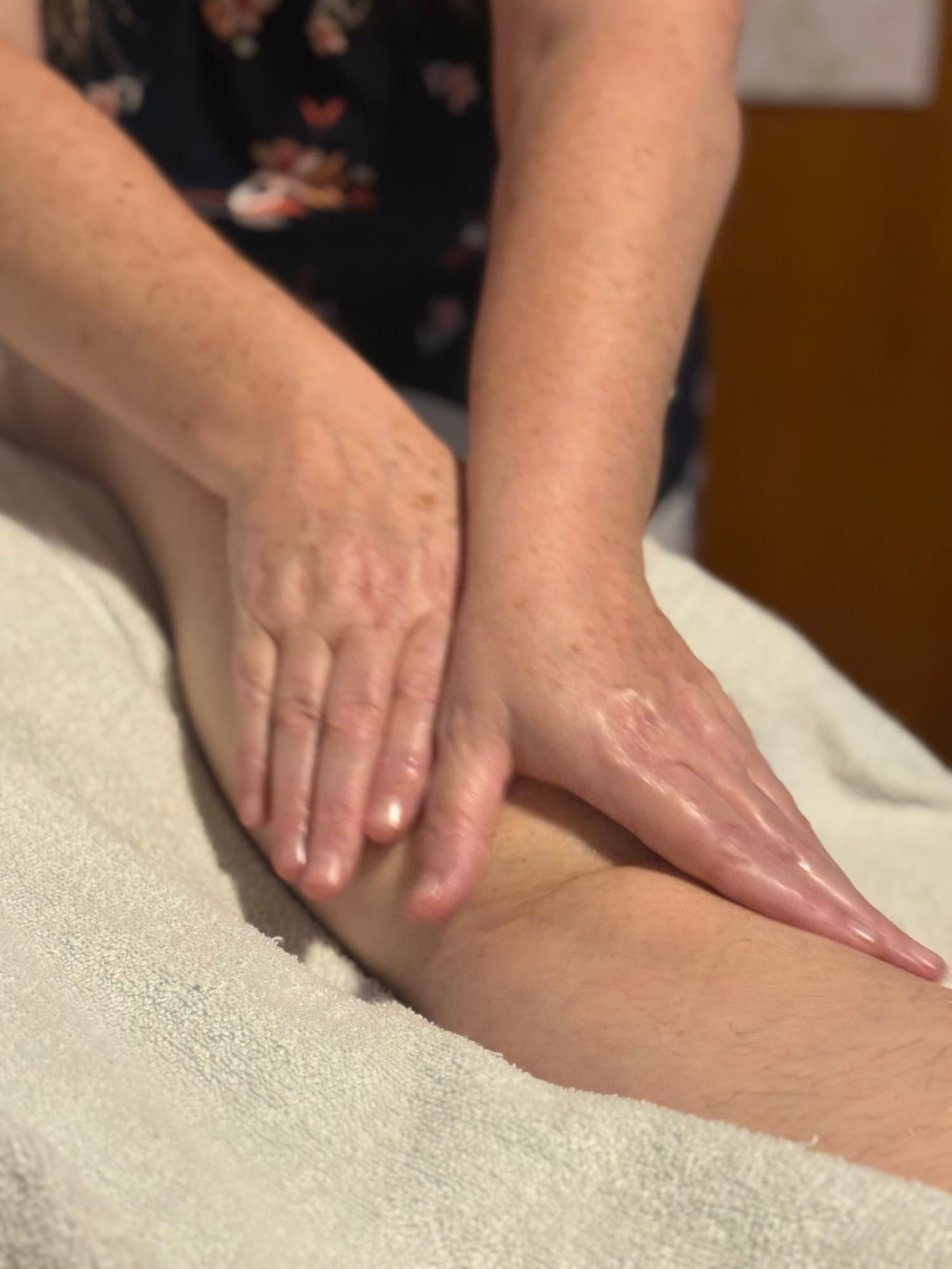 Nicole providing hands-on full-body massage at her Riverside practice